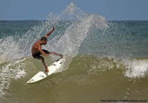 Surfer rides waves with a cut