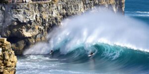 Surfers tackle massive waves at the Nazaré Challenge.
