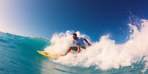 Hugues Oyarzabal surfing a massive wave with ocean spray.