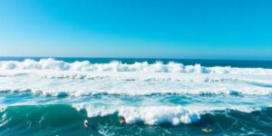 Surfers riding massive waves at Kirra beach, Queensland.