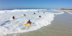 Surfers catching waves at Surf City, El Salvador.