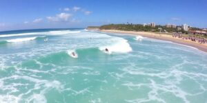 Surfers riding waves at Punta Roca during competition.