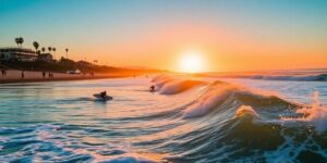 Surfers riding waves at Lower Trestles beach during sunset.