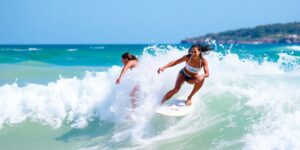 Gabriela Bryan and Jordy Smith surfing waves in El Salvador.