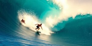 Surfers riding waves during a competitive surf event.
