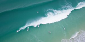 Surfers competing in waves at Bells Beach tournament.