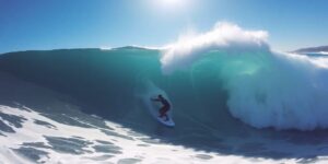 Surfer on a blue ocean wave