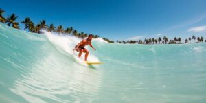 Surfer rides artificial wave.