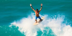 Surfer celebrates victory on a wave.