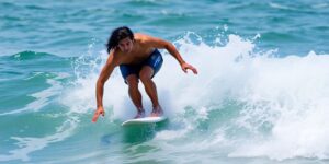 Surfer Kolby Aipa riding a wave