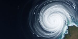 Hurricane approaching Mexican coast with dark clouds and large waves.