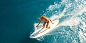 Ginger Caimi surfs a wave.