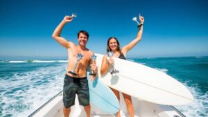 Surfers celebrate with trophies on a boat after winning.