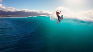 Surfer performs aerial on giant wave in Fiji.