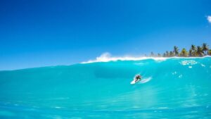 Surfer riding a massive wave in Fiji