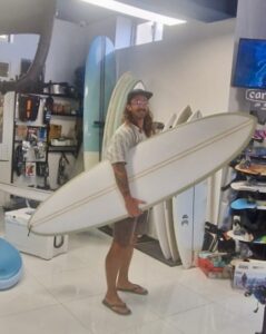 Surfer holding new surfboard in Malta