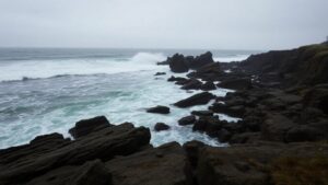 Turbulent waves crash on a rocky shore near Siletz Bay.