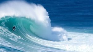 Surfer riding a giant wave at Pipeline, Hawaii.