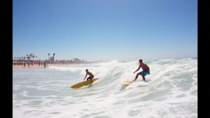 Lindblad and Slawson surfing at sunny California beach