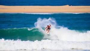 Surfer catches a wave at Corona Cero Surf Open Cerritos.