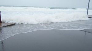 Flooded coastal street with high surf in Southern California.