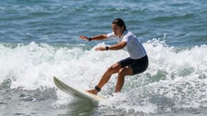 Female surfer riding a wave at the Super Girl Surf Pro.