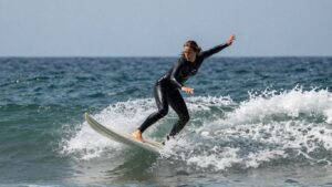 [Leilani McGonagle] surfing a wave during a competition.