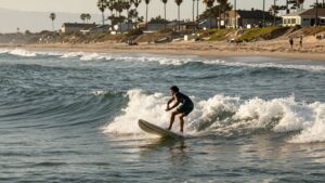 Surfers enjoying waves at Encinitas beach.