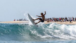 Surfer catches a wave at Corona Cero Surf Open Cerritos.