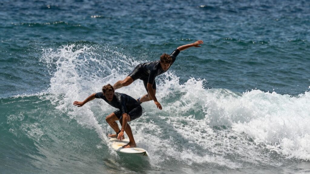 Surfers riding waves in a competition.