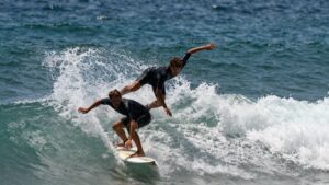 Surfers riding waves in a competition.
