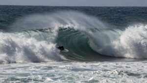 Giant wave crashes at Nazaré during big wave challenge.