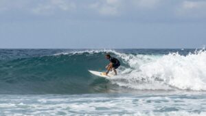 Surfer battling rough waves during a competition.