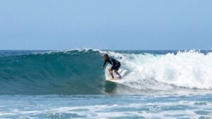 Surfer riding a wave in Malibu.