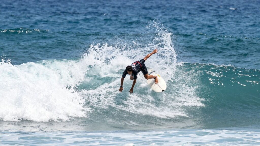 Surfers riding powerful waves in a championship competition.