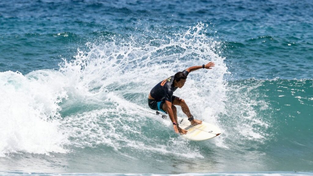 Surfers riding waves in the ocean.